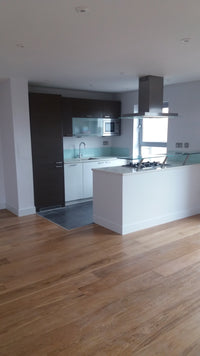 Modern interior with a staircase and glass balustrade in a well-lit room.