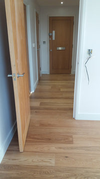 Wooden shelf inside a kitchen cabinet with white interior