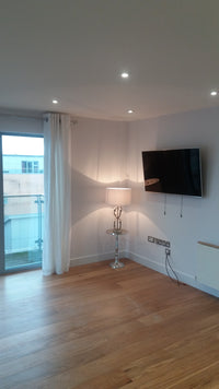 Underground parking garage with concrete floor and white pillars