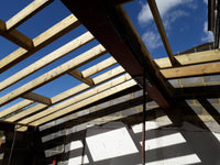 Construction site with metal frame and stone wall