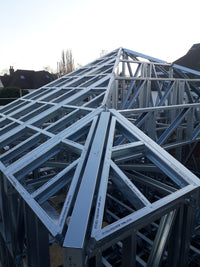 Stack of metal frames with visible branding on a white background