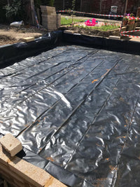 Black waterproofing membrane on a construction site