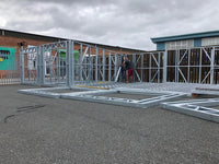 Construction site with a metal frame structure under construction.