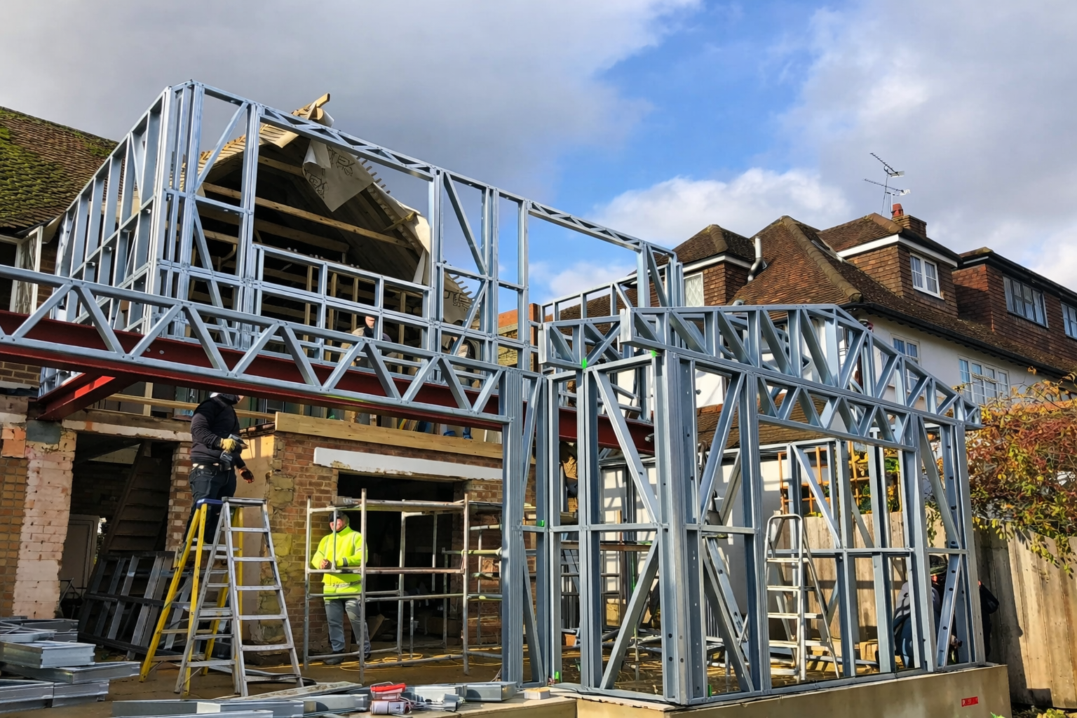 Construction site with a metal frame structure against a blue sky.