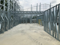 Under construction building with metal frame and concrete floor