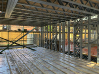 Construction site with metal framing and wooden floor