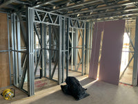 Construction site with metal framing and drywall panels
