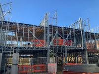 Construction site with metal scaffolding and blue sky