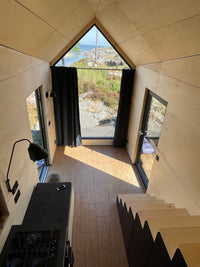 Modern interior with a large window overlooking a scenic landscape