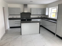 Modern kitchen with gray cabinets and black countertops