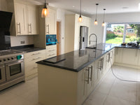Modern kitchen with black countertops and white cabinets