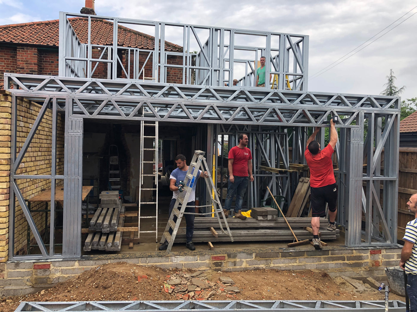 Construction site with metal frame and stone wall