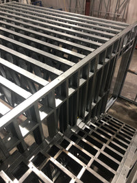 Metal pallets stacked in a warehouse setting