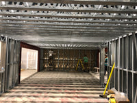 Underconstruction building with metal framing and tools visible