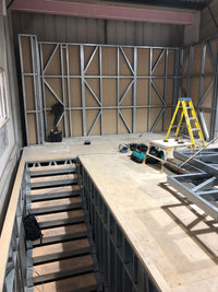 High rack storage system with metal shelves and a forklift in an industrial setting