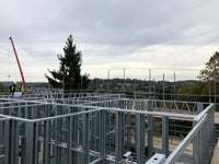 Construction site with metal frame structure against a cloudy sky