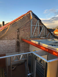 Construction site with scaffolding and a partially completed building exterior.