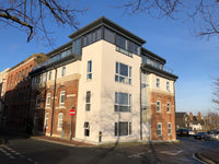 Construction site with metal frame and stone wall