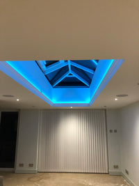 Modern interior design with a blue light accent on a wall.