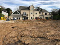 Large house under construction with a cleared area in front