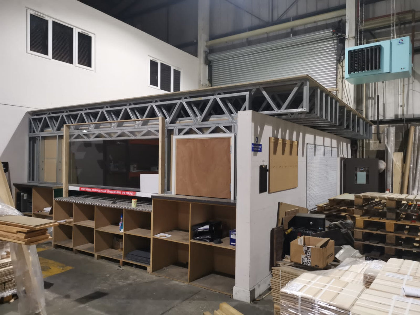 Warehouse interior with shelves, boxes, and pallets.